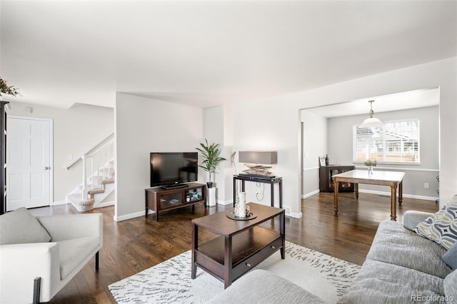 12945 E Colorado Ave, Aurora, CO 80012 - living room with baseboards, stairs, and wood finished floors