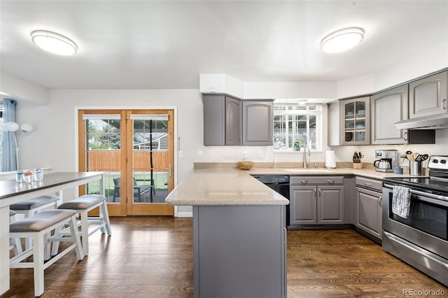 12945 E Colorado Ave, Aurora, CO 80012 - kitchen with stainless steel range with electric stovetop, a peninsula, under cabinet range hood, a wealth of natural light, and gray cabinetry