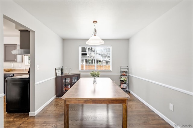 12945 E Colorado Ave, Aurora, CO 80012 - dining room featuring baseboards and dark wood-style flooring