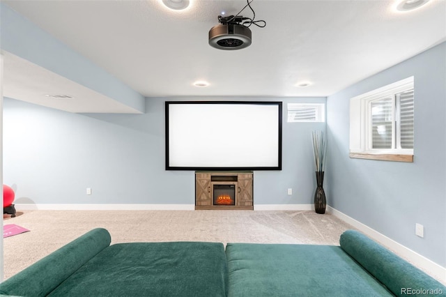 12945 E Colorado Ave, Aurora, CO 80012 - carpeted home theater featuring baseboards, a lit fireplace, and visible vents