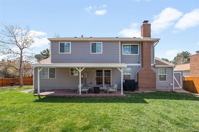 12945 E Colorado Ave, Aurora, CO 80012 - rear view of house with an outdoor hangout area, a fenced backyard, a chimney, a patio, and a yard