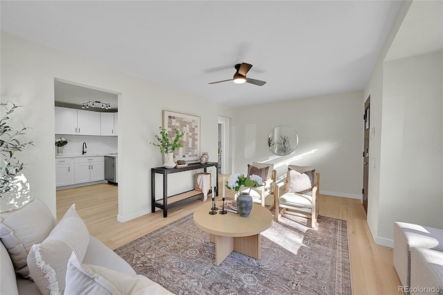 living room featuring ceiling fan and light hardwood / wood-style flooring