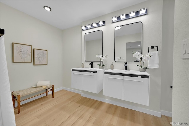 bathroom with vanity and hardwood / wood-style flooring