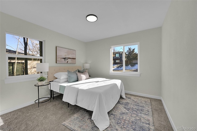 carpeted bedroom featuring multiple windows