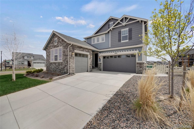 6802 S Uriah St, Aurora, CO 80016 - craftsman-style home featuring stone siding, driveway, and an attached garage