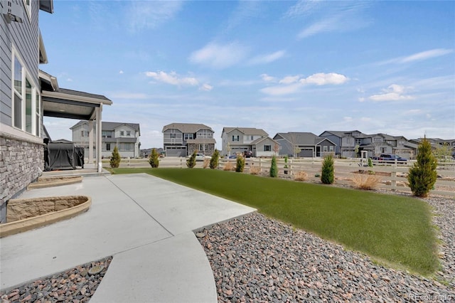 6802 S Uriah St, Aurora, CO 80016 - view of green lawn featuring a residential view and a patio area
