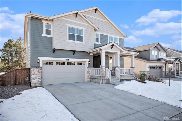 craftsman-style house featuring covered porch and a garage