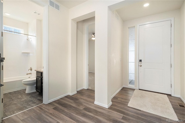 foyer with dark hardwood / wood-style floors and ceiling fan