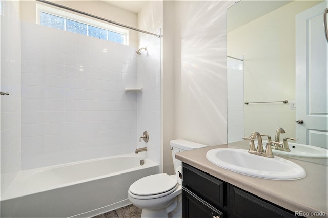 full bathroom with hardwood / wood-style flooring, vanity, toilet, and tiled shower / bath