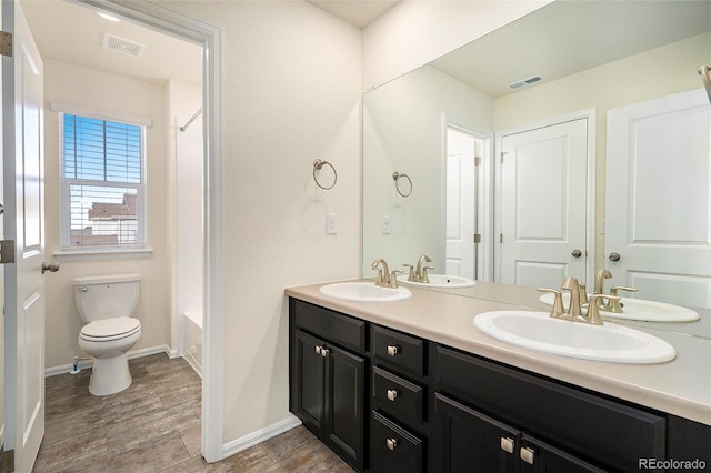 full bathroom with vanity, hardwood / wood-style floors,  shower combination, and toilet