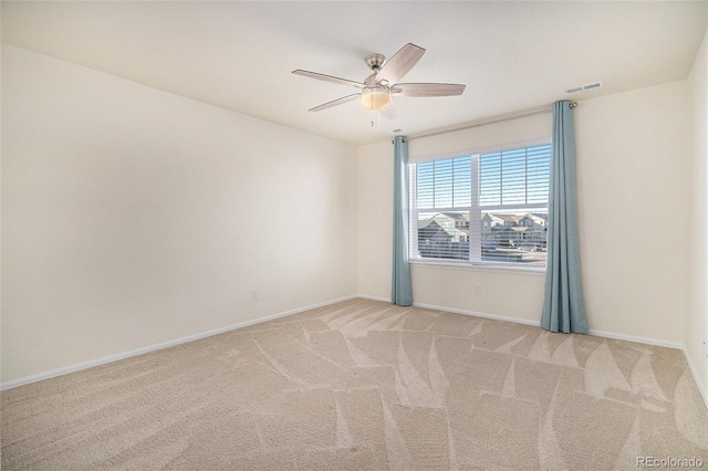 carpeted spare room featuring ceiling fan