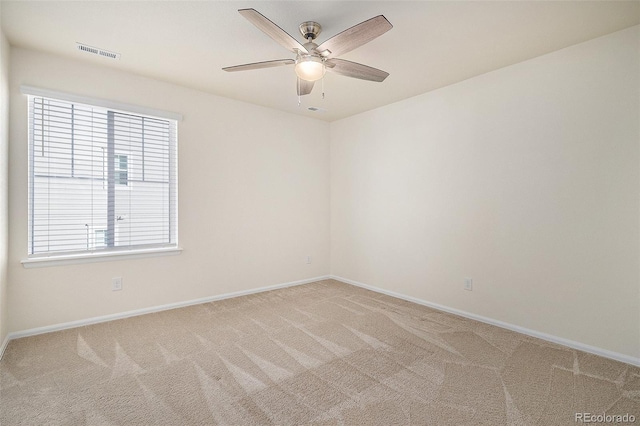 unfurnished room featuring light carpet and ceiling fan