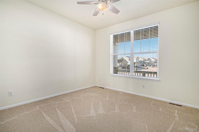 unfurnished room featuring ceiling fan and carpet floors