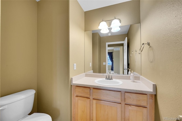 bathroom with toilet and vanity