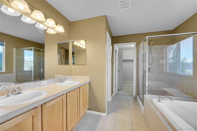 bathroom with tile patterned floors, a bath, a stall shower, and double vanity