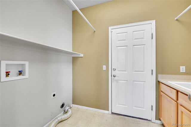 laundry room with hookup for an electric dryer, cabinet space, washer hookup, and baseboards