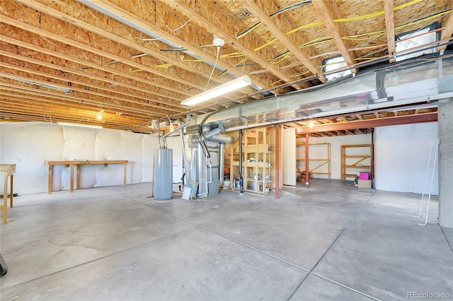 unfinished basement featuring water heater and heating unit