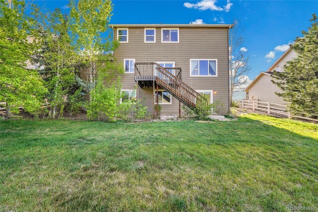 rear view of house with stairway and a deck
