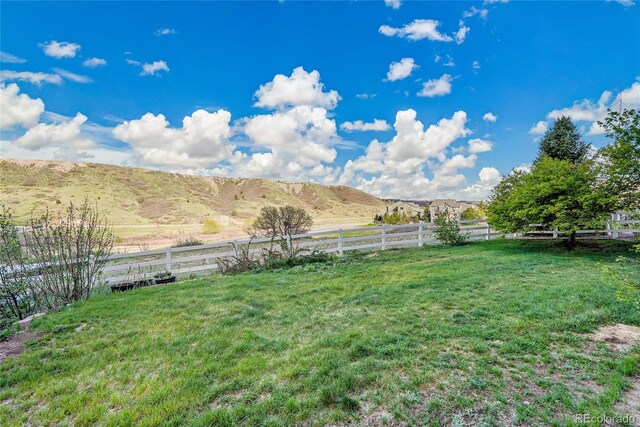 view of yard featuring a view of rural / pastoral area and a mountain view