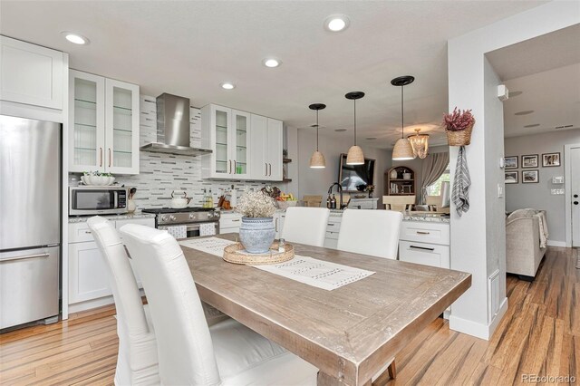 10042 Hudson St, Thornton, CO 80229 - dining room with light wood-style floors and recessed lighting