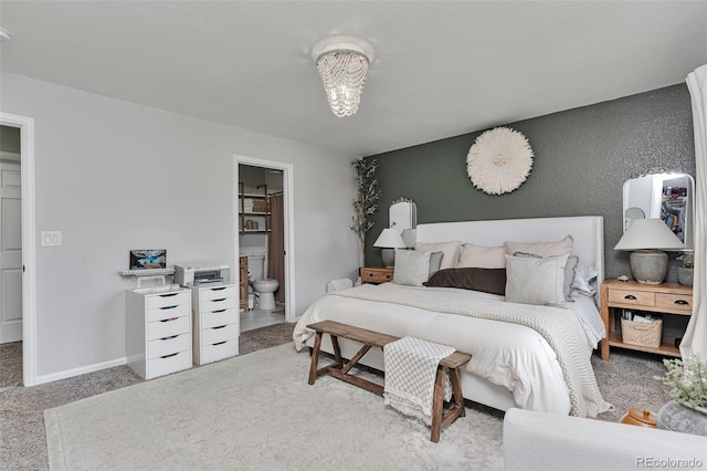 10042 Hudson St, Thornton, CO 80229 - carpeted bedroom featuring ensuite bath and baseboards
