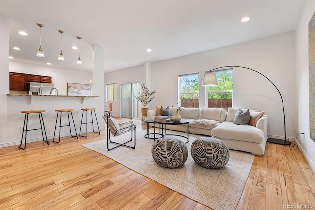 4190 W Alameda Ave, Denver, CO 80219 - living area with light wood-style floors, recessed lighting, and baseboards