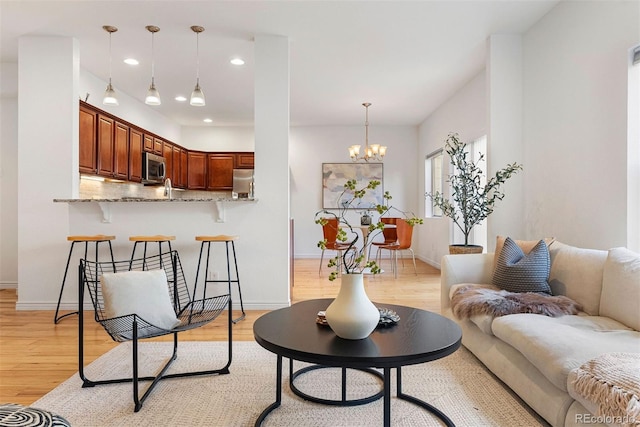 4190 W Alameda Ave, Denver, CO 80219 - living area with light wood-type flooring, baseboards, a chandelier, and recessed lighting