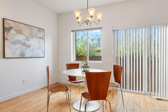 4190 W Alameda Ave, Denver, CO 80219 - dining area with hardwood / wood-style floors, a chandelier, and baseboards