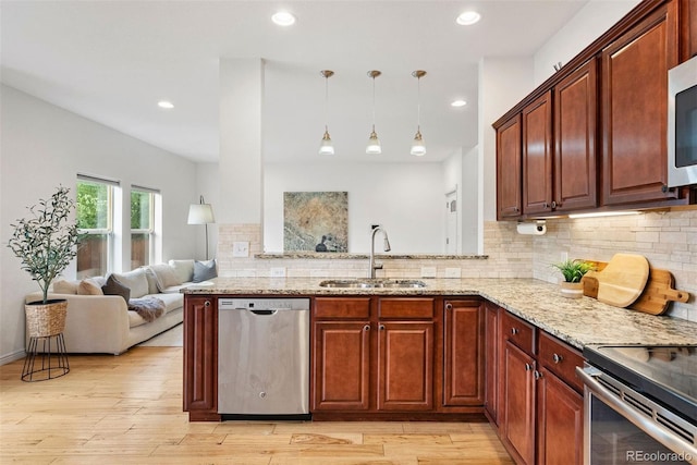 4190 W Alameda Ave, Denver, CO 80219 - kitchen with stainless steel appliances, a sink, light stone countertops, tasteful backsplash, and recessed lighting