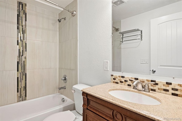 4190 W Alameda Ave, Denver, CO 80219 - bathroom with a textured wall, toilet, vanity, shower / washtub combination, and decorative backsplash