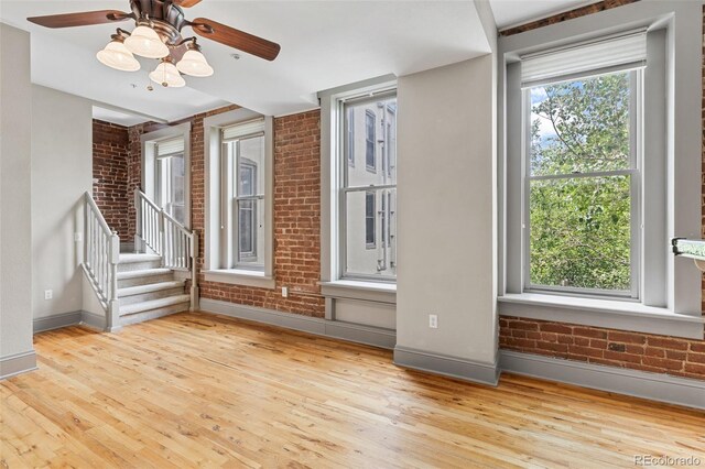 3211 Zuni St Unit 9, Denver, CO 80211 - spare room featuring brick wall, wood finished floors, and ceiling fan