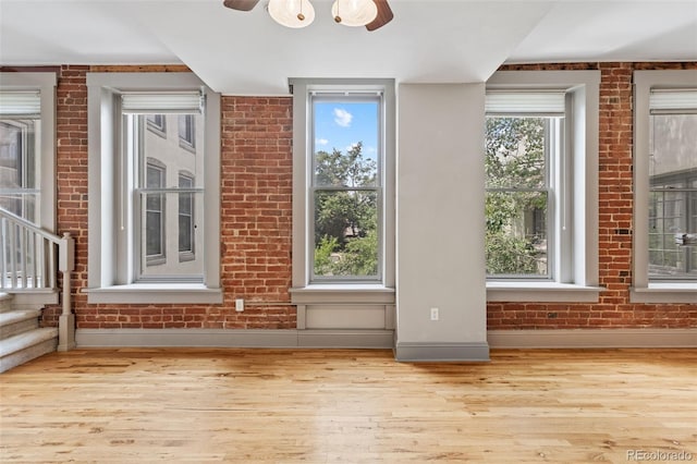 3211 Zuni St Unit 9, Denver, CO 80211 - interior space with wood finished floors, ceiling fan, brick wall, and stairway