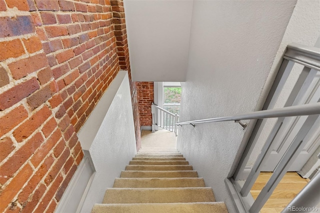 3211 Zuni St Unit 9, Denver, CO 80211 - stairway with brick wall and a textured wall