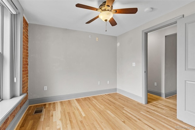 3211 Zuni St Unit 9, Denver, CO 80211 - empty room featuring light wood-style flooring, a ceiling fan, brick wall, and a smoke detector