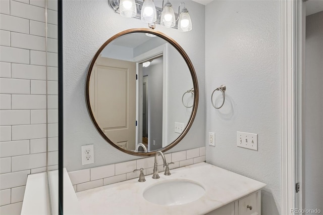 3211 Zuni St Unit 9, Denver, CO 80211 - bathroom featuring vanity, a textured wall, and backsplash