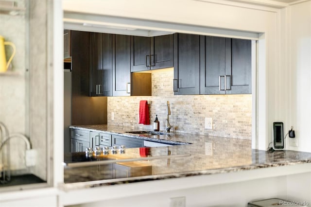 5607 Crawford Gulch Rd, Golden, CO 80403 - kitchen featuring backsplash and light stone counters