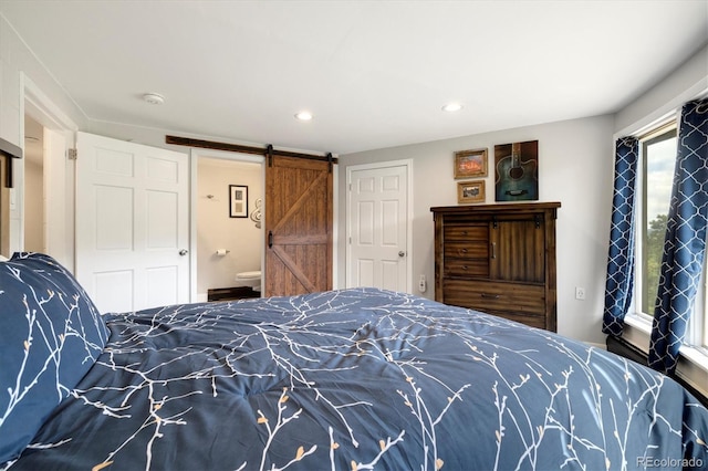 5607 Crawford Gulch Rd, Golden, CO 80403 - bedroom featuring a barn door, recessed lighting, and connected bathroom
