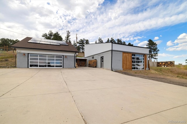 5607 Crawford Gulch Rd, Golden, CO 80403 - garage featuring solar panels and concrete driveway