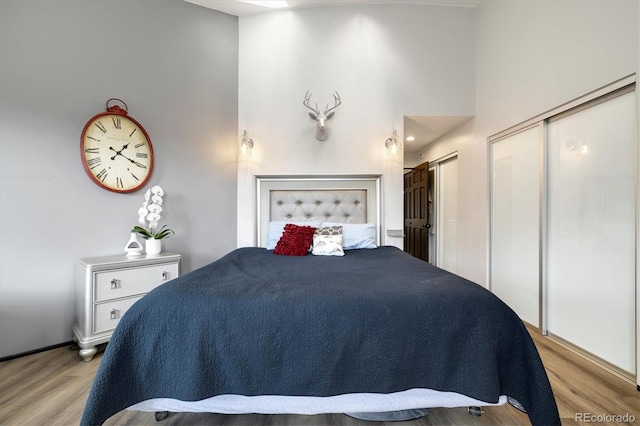 5607 Crawford Gulch Rd, Golden, CO 80403 - bedroom featuring light wood-type flooring and a towering ceiling