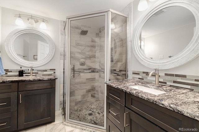 5607 Crawford Gulch Rd, Golden, CO 80403 - full bathroom featuring marble finish floors, a shower stall, two vanities, and decorative backsplash