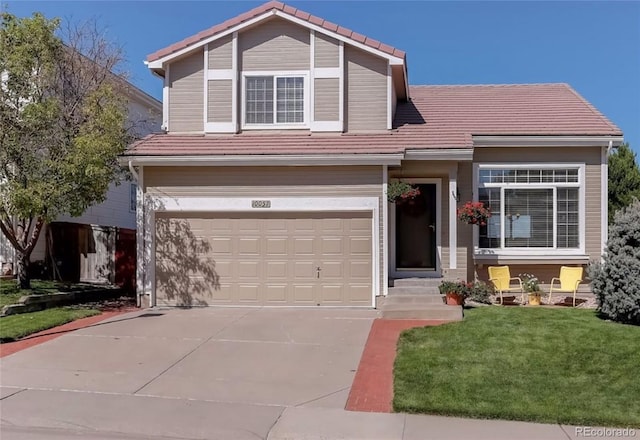 view of front of home featuring a garage, a tile roof, a front lawn, driveway, and entry steps