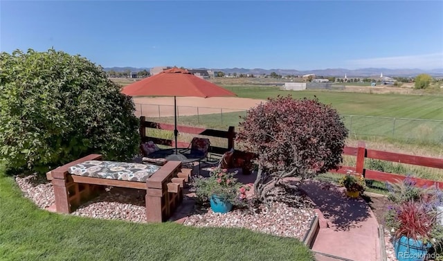 view of yard with a view of rural / pastoral area and a mountain view