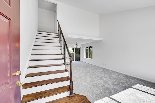 staircase featuring carpet floors and baseboards