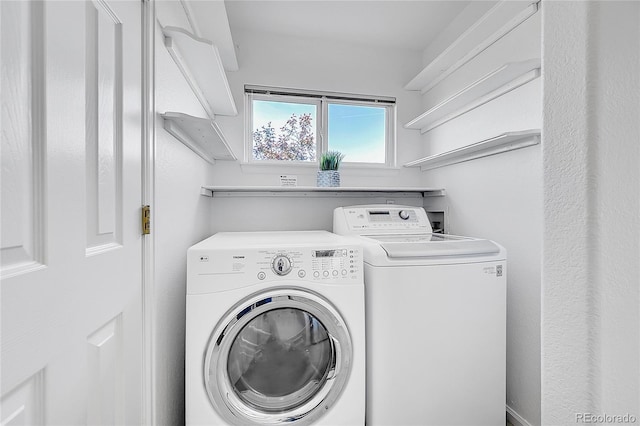 laundry room featuring washing machine and clothes dryer