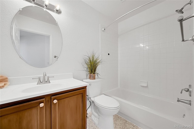 bathroom featuring vanity, toilet, speckle patterned floor, and bathing tub / shower combination