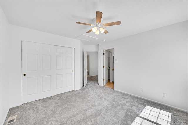 unfurnished bedroom featuring carpet, baseboards, a closet, and a ceiling fan