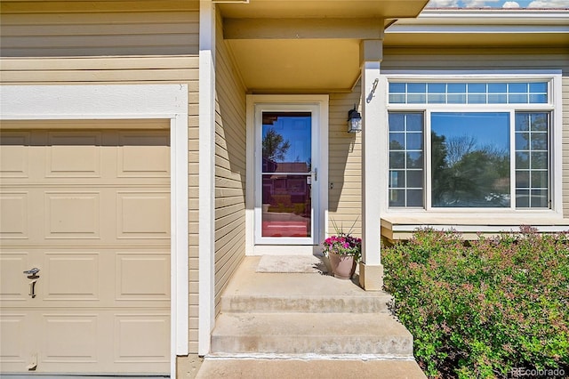 doorway to property featuring an attached garage