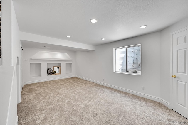 unfurnished living room with carpet flooring, recessed lighting, and baseboards