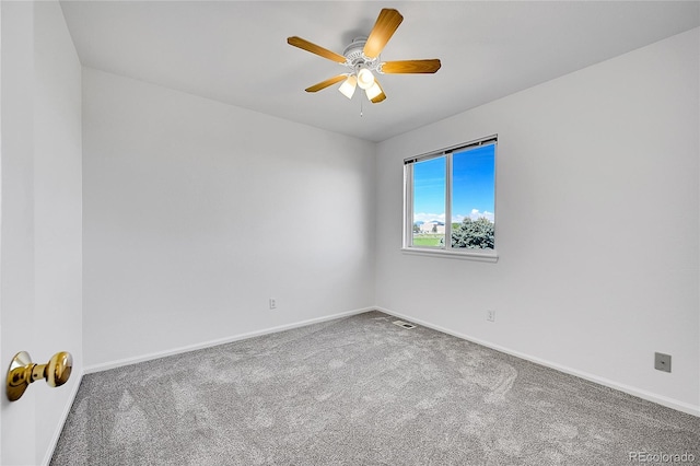 carpeted empty room with baseboards and ceiling fan