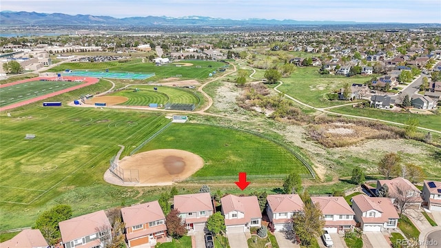 aerial view of property and surrounding area with a mountainous background and nearby suburban area